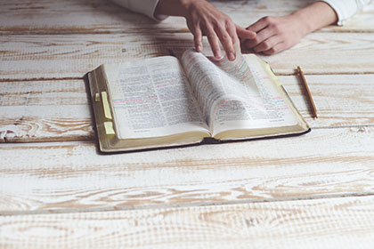 hands, female, opening Bible